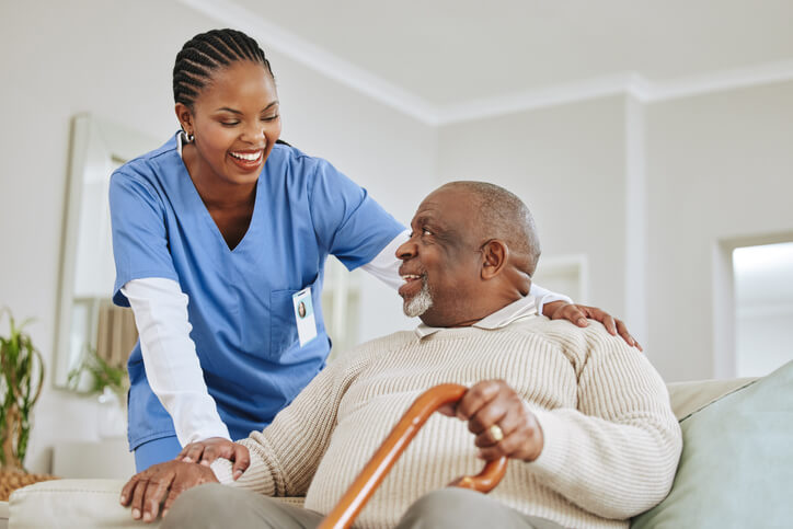 Practical nurse helping a patient in a hospital rehabilitation unit after practical nurse training