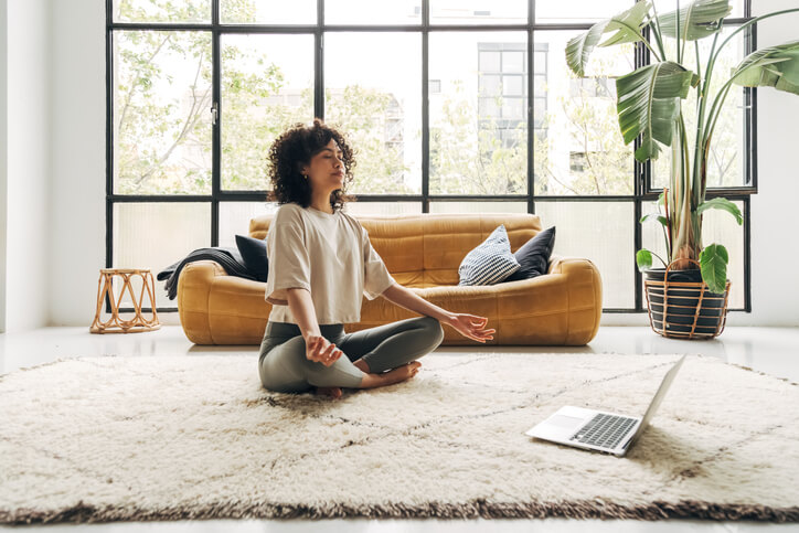 Female community support worker meditating.