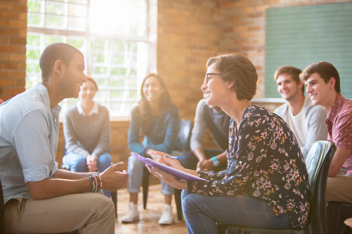 A community worker in a group session with clients after community support worker training