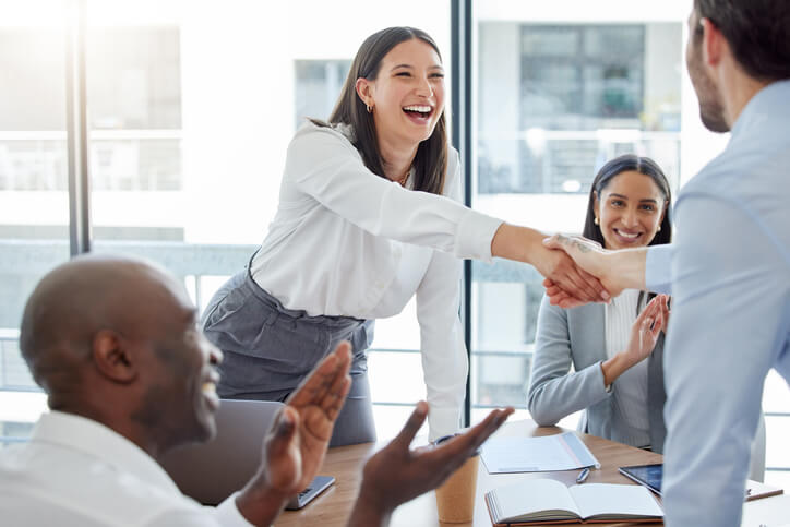office management training grad shaking hands with a new hire