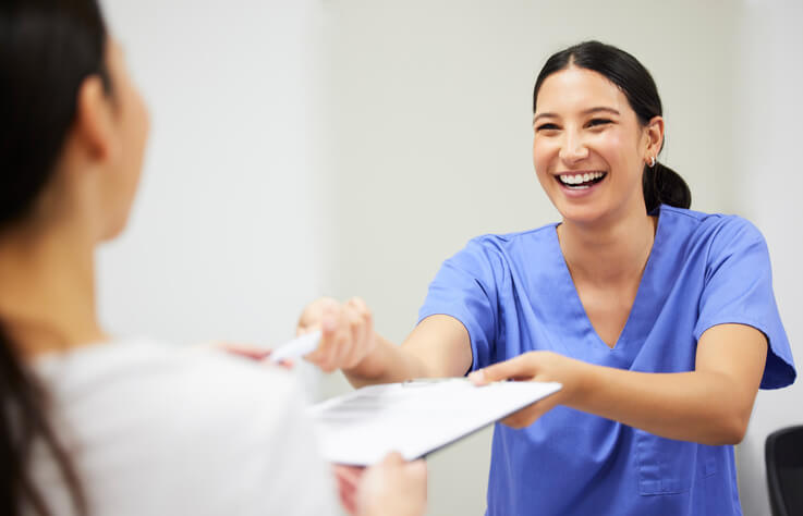 Female dental assistant interacting with a patient after dental assistant training