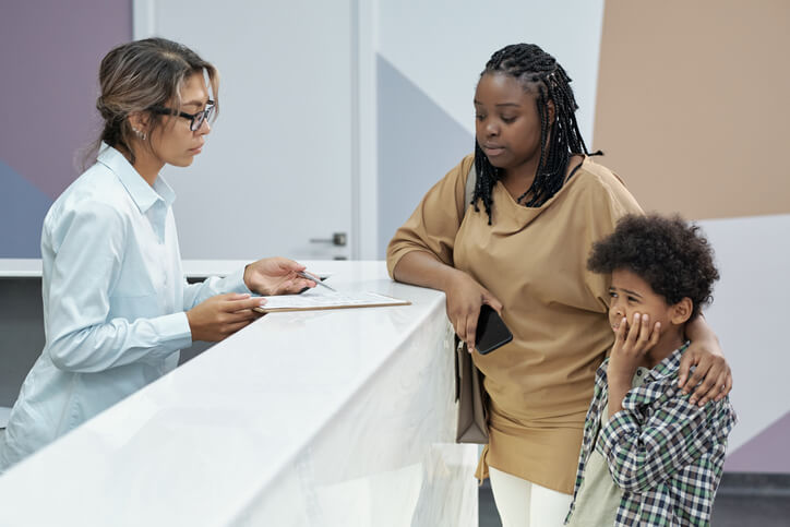 A dental assistant taking client information after dental assistant training
