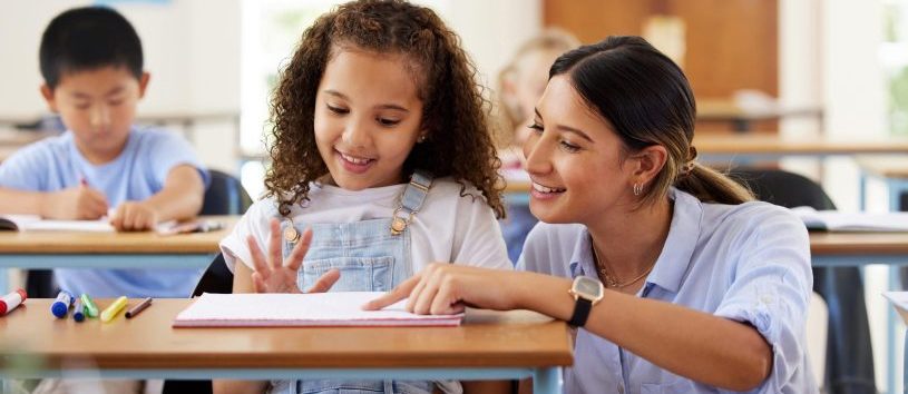 Education Assistant helping a female student.