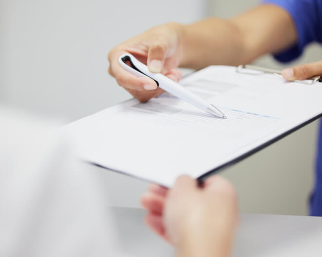 A dental assistant training graduate invoicing a patient.