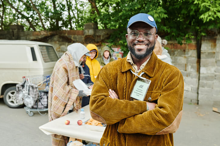 A community support worker running a feeding program for homeless clients.