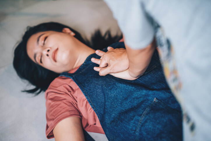 A practical nurse performing emergency CPR on an unconscious patient after practical nurse training.