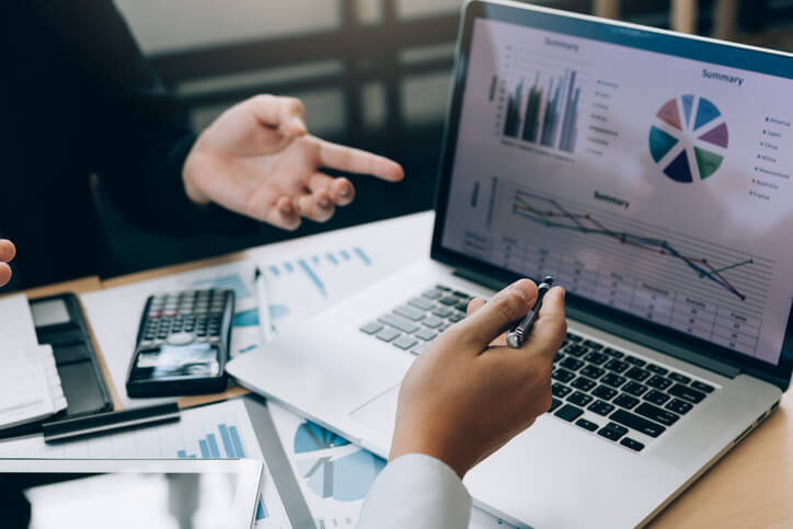 A finance business management training grad using a data analytics tool