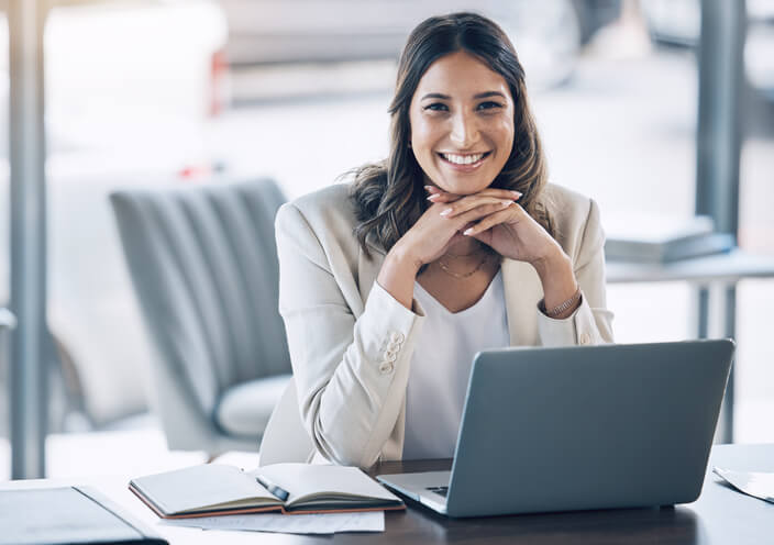 A finance business management training grad working at a desk