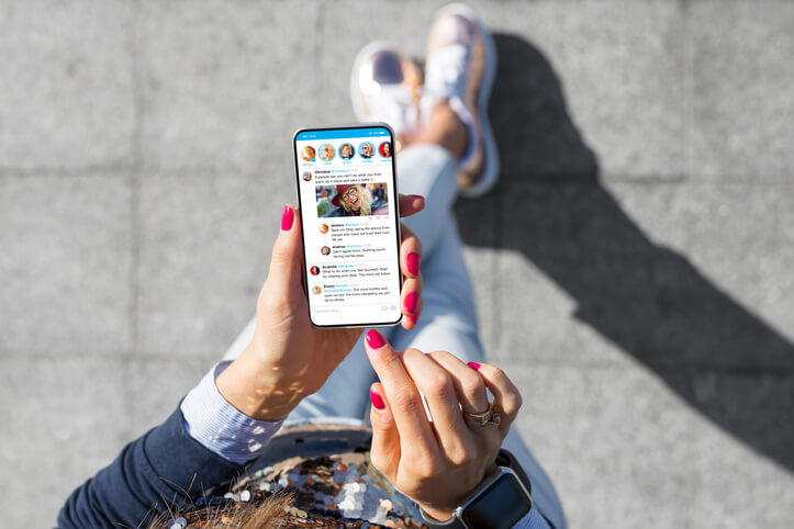 A digital marketing professional consuming short-form video content on a smartphone after completing digital marketing training
