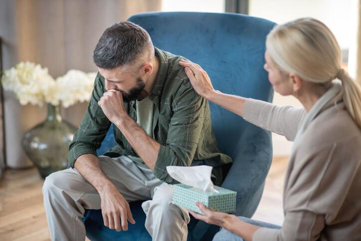 Mental health worker with an emotionally distressed patient after community support worker training
