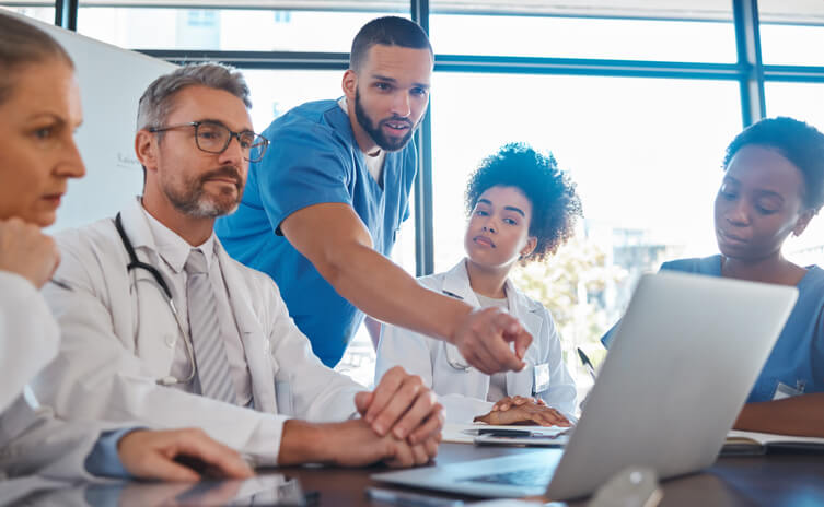 A medical office management training graduate collaborating with the healthcare team
