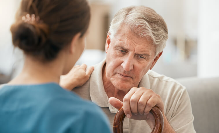 A female healthcare assistant interacting with a distressed patient after completing her healthcare assistant training