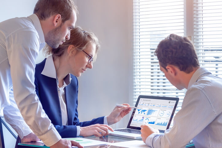 A group of SEO experts checking out analytics data after completing their digital marketing training